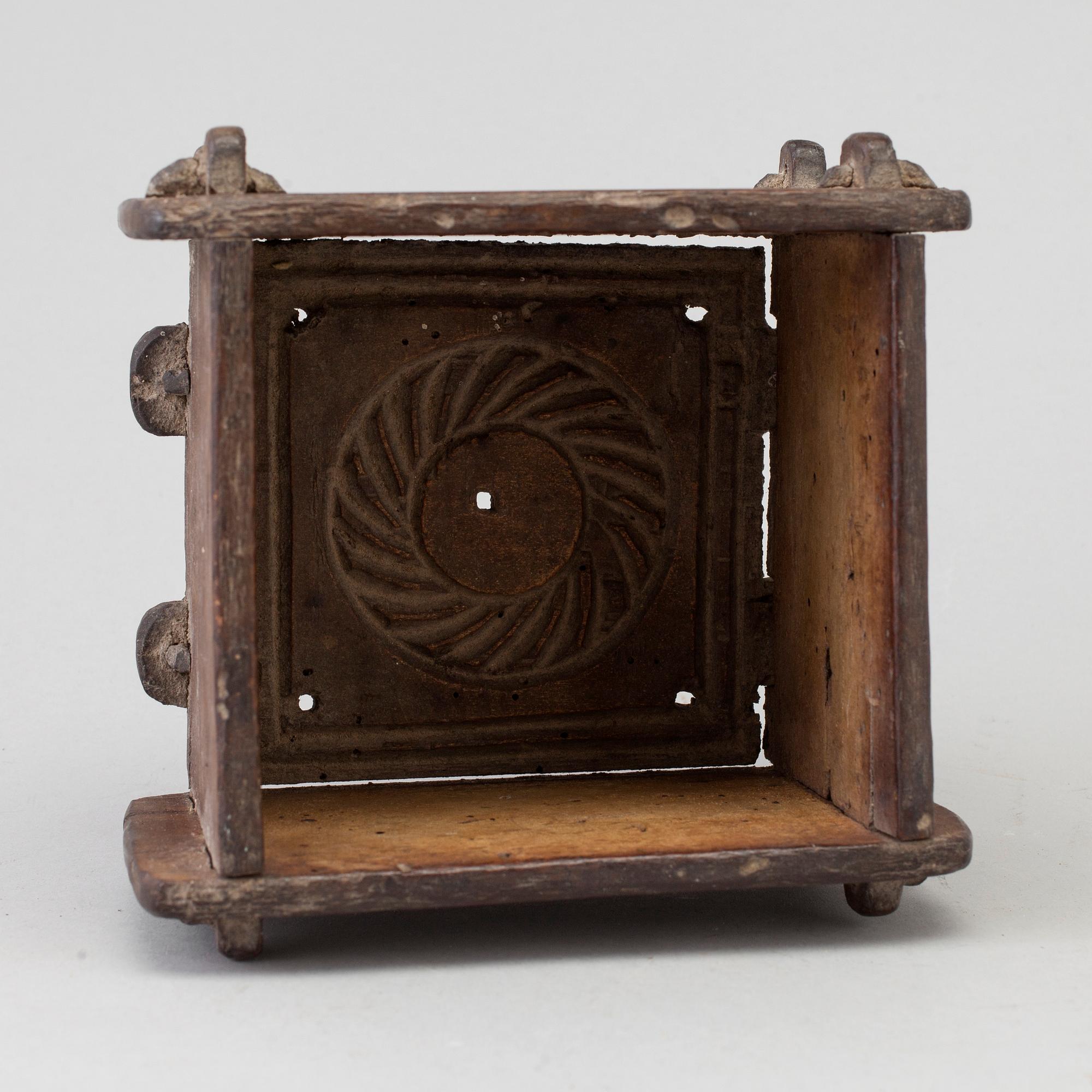 A cheese mould, dated 1768.