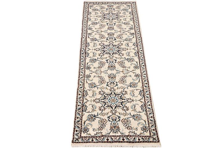 A Nain runner carpet, part silk, c. 298 x 80 cm.