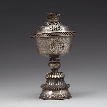 A Tibetan silver butter lamp with cover, 19th Century.