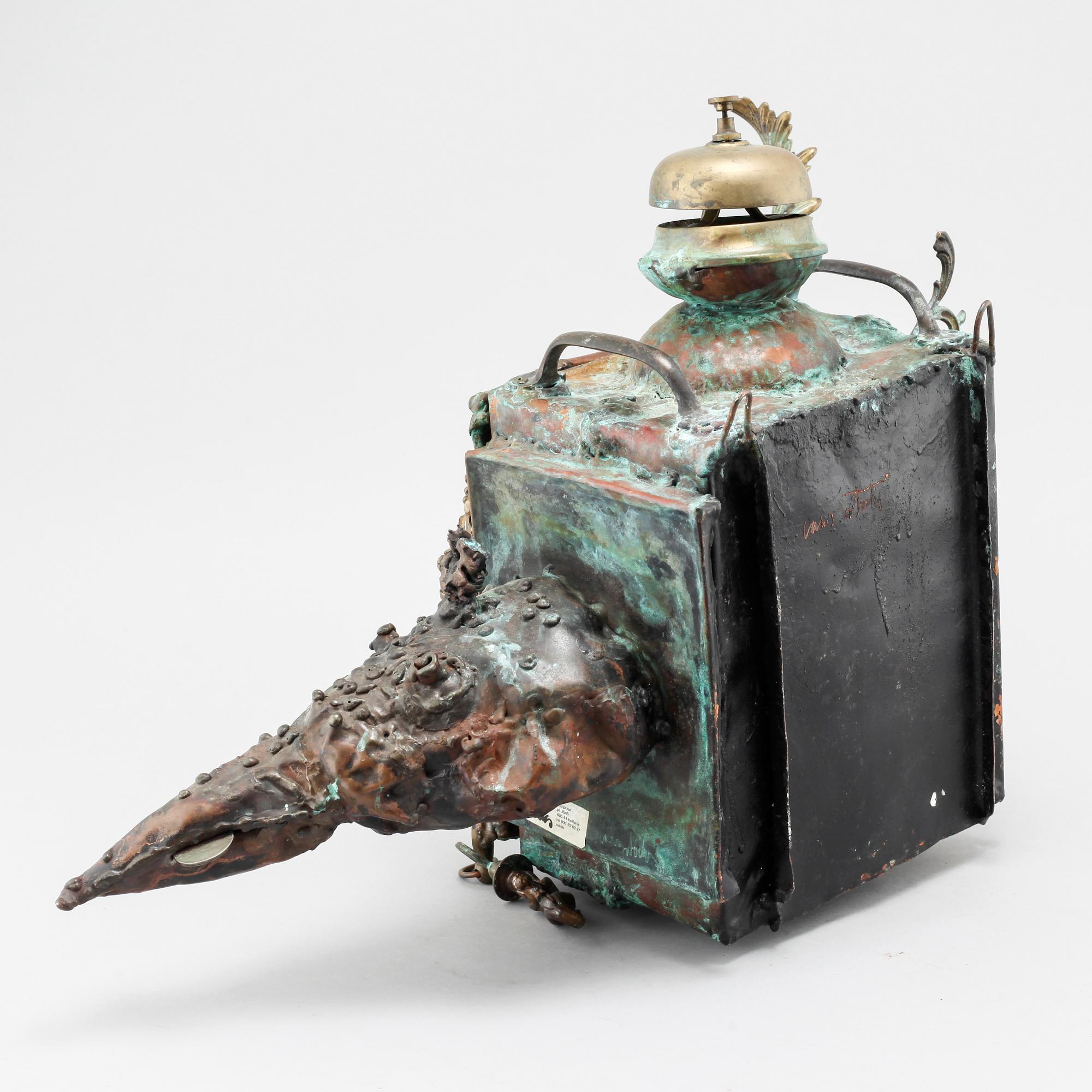 a metal sculpture, signed.
