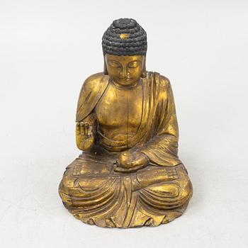 A massive gilded wooden figure of buddha, 20th century.