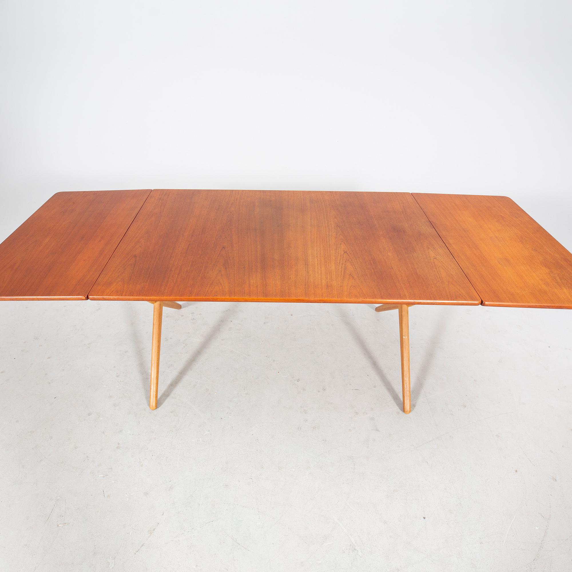 A Hans J Wegner "Savbukkebordet AT-303", teak and oak drop-leaf dining table, Andreas Tuck, Denmark 1950s-1960s.