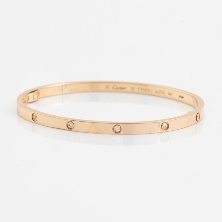 A Cartier "Love" bracelet small model in 18K rose gold with ten round brilliant-cut diamonds.