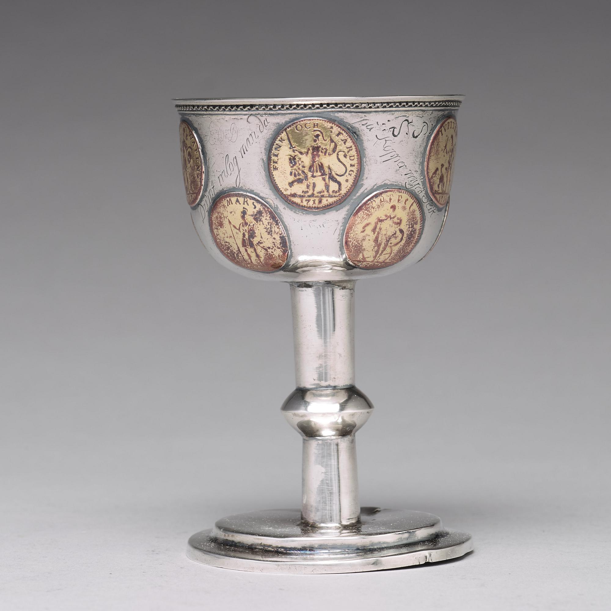 A Swedish 18th century parcel-gilt silver tumbler / cup, with copper coins, unmarked.