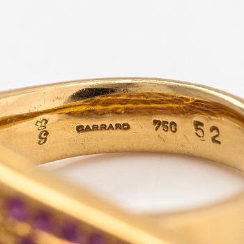 Garrard, An 18K gold ring "Wings" with rubies. Marked Garrard 52 Austria.