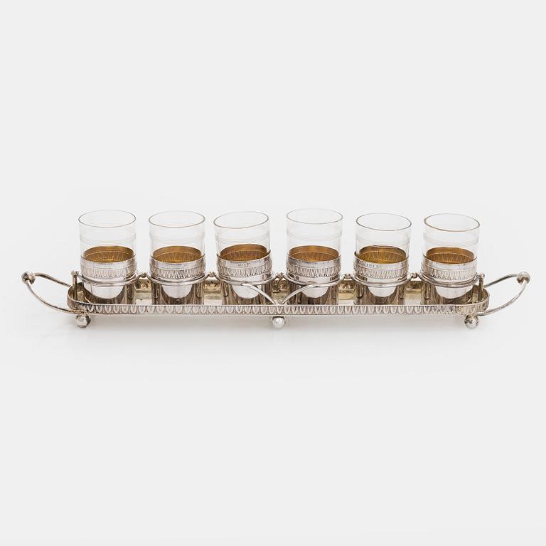 A set of six shot glasses with a tray in original fitted box, silver and glass, likely Norway 1910s.