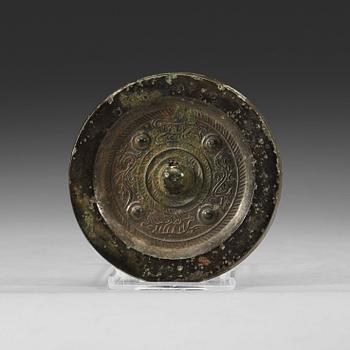 95. A bronze mirror decorated with stylized dragons and tigers, Eastern Han dynasty (25-220).