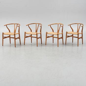 Hans J Wegner, a set of four model CH-24 ”Wishbone” chairs, Carl Hansen & Son, Odense, Denmark.