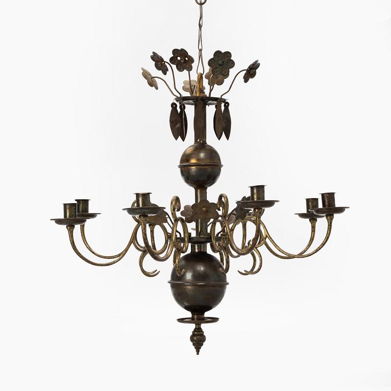 A Baroque style brass chandelier from around the year 1900.