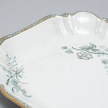 A earthenware table set of 136 pcs "Vexiö Guld",  by Arvid Ekberg, Gustafsberg, from around year 1900.
