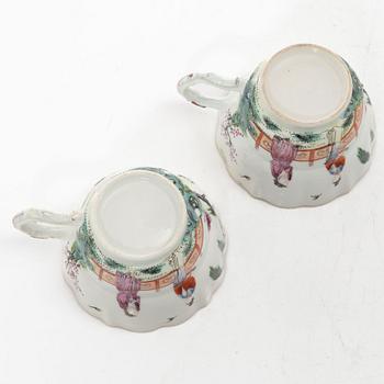 A pair of Chinese famille rose teacups with saucers and a pair of plates and two dishes, Qing dynasty, 18th century.