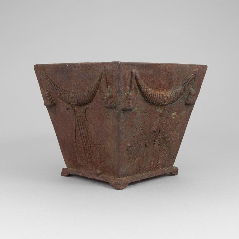 An early 19th century flower pot of cast iron.