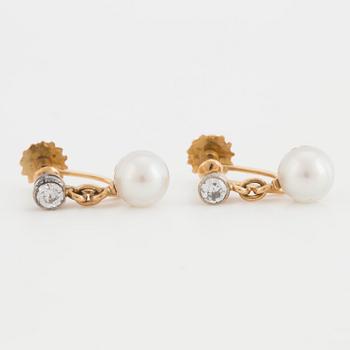 A pair of earrings set with cultured pearls and old-cut diamonds.