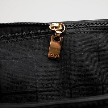 CÉLINE, a black patent leather purse.