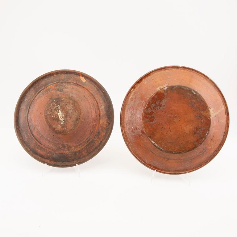 Two bowl plates ("Äggakagefat") 2 pieces from Skåne, one dated 1748 and 1891, engobed earthenware.