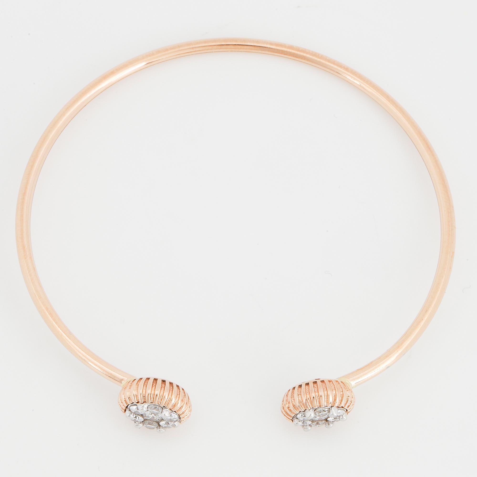 An 18K rose gold bracelet set with round brilliant-cut diamonds.