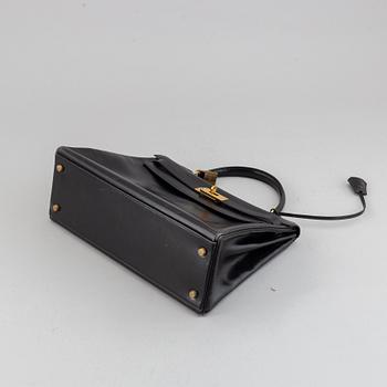 Hermès,a black leather 'Kelly 32' handbag, 1975.