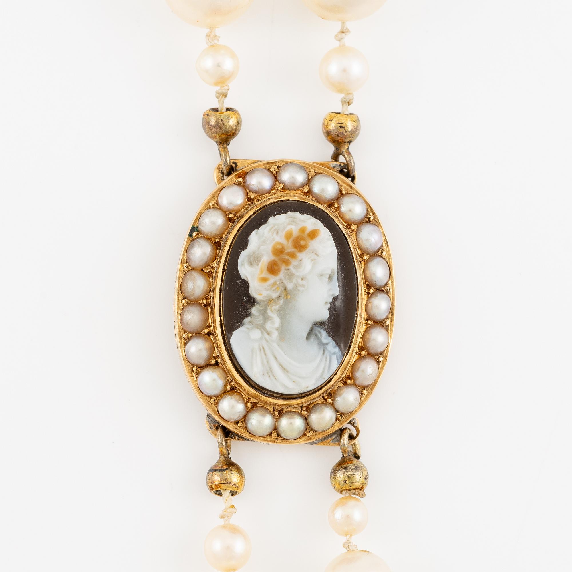 Necklace of two strands of cultured pearls, clasp 18K gold with a hardstone cameo.