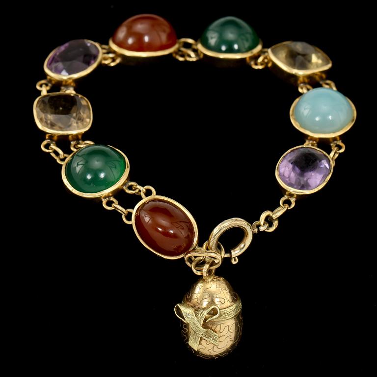 ARMBAND, 18k guld med cabochonslipade och fasettslipade stenar, 1900-tal. Vikt 27.