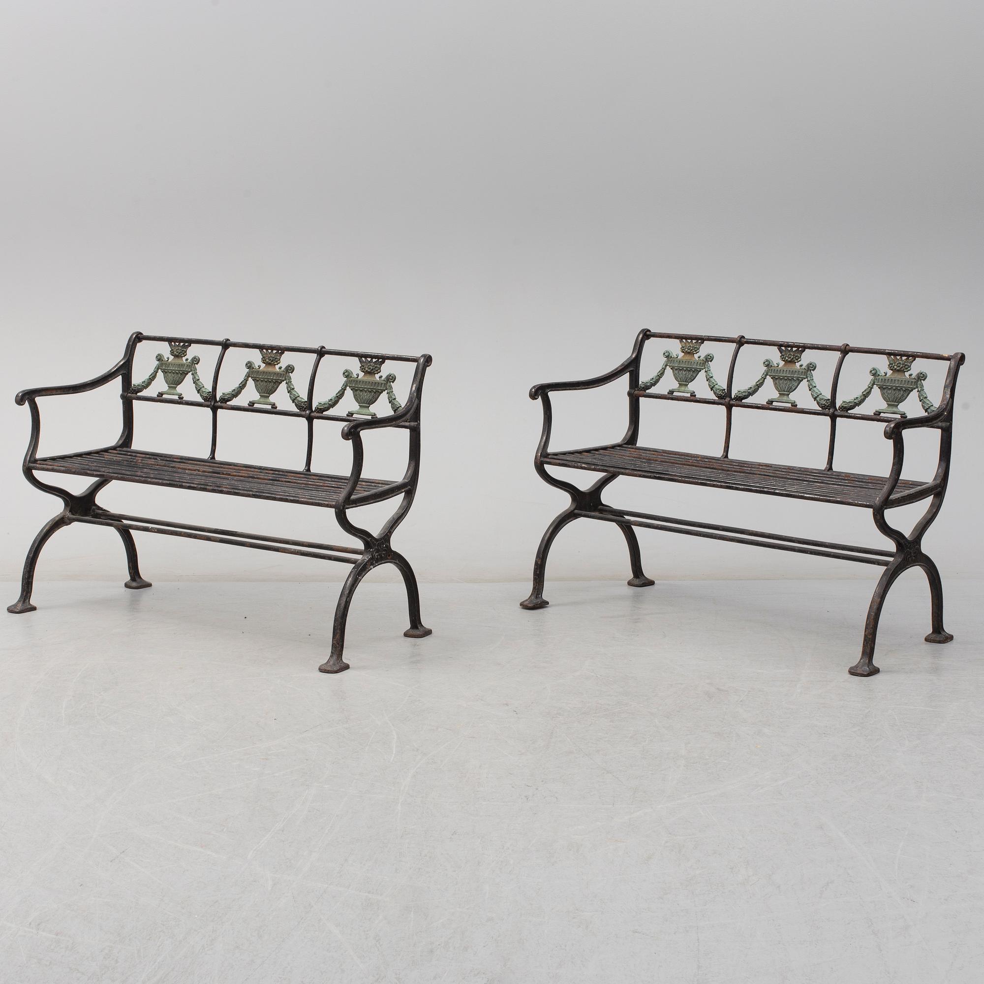 GARDEN SOFAS, a pair, cast iron, empire style, late 19th century.