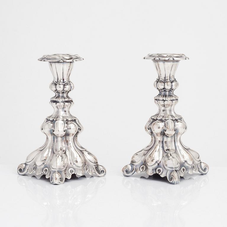 Two similar baroque style silver candlesticks by Kultakeskus, Hämeenlinna 1948 and Hopeatehdas Oy, Helsinki 1953.