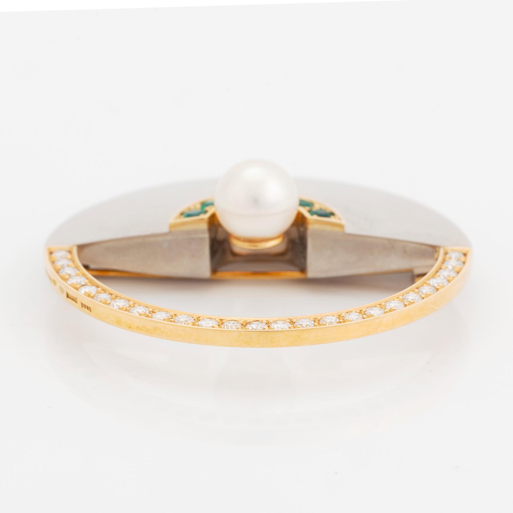An 18K gold and white gold brooch set with a cultured pearl, round brilliant-cut diamonds and emeralds.