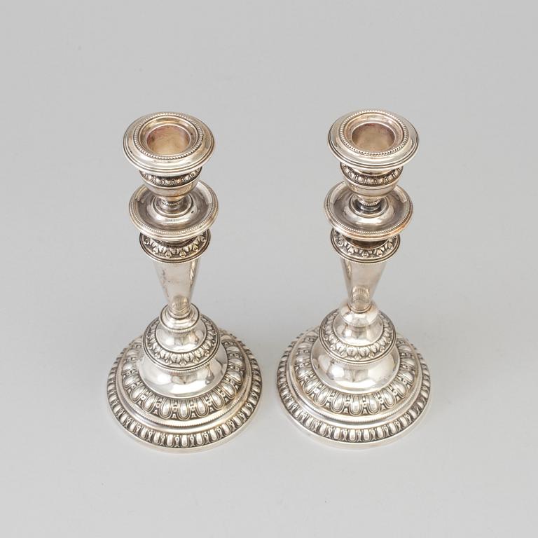 A pair of silver candle sticks, dated 1903.
