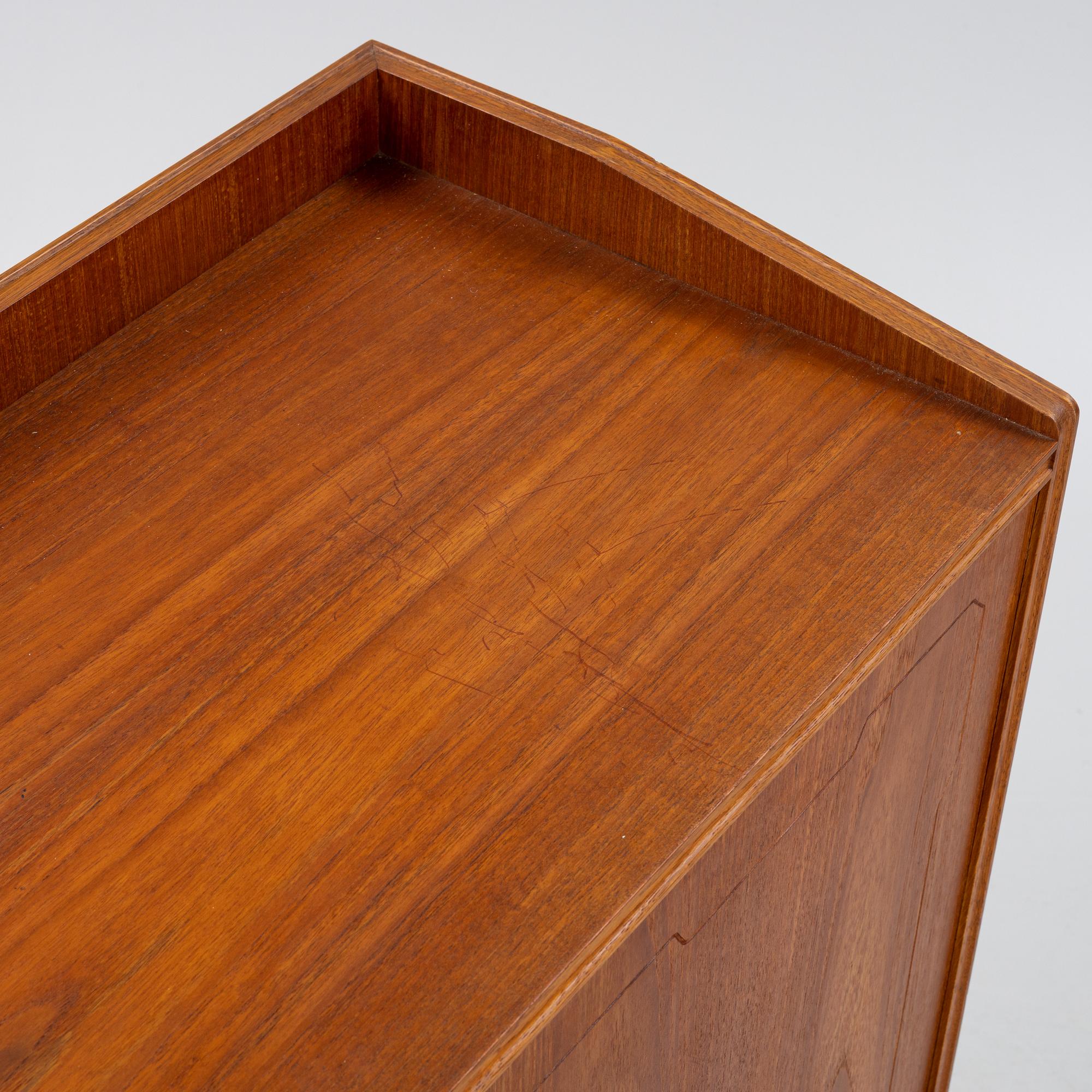 A teak-veneered mid 20th century sideboard.