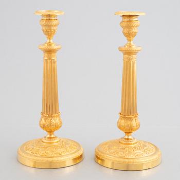 A pair of French Empire gilt.bronze candlesticks, early 19th century.