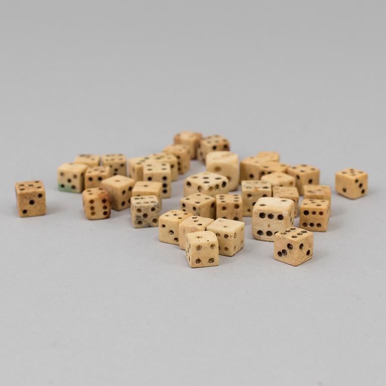 A COLLECTION OF 34 BONE MINIATURE DICE.