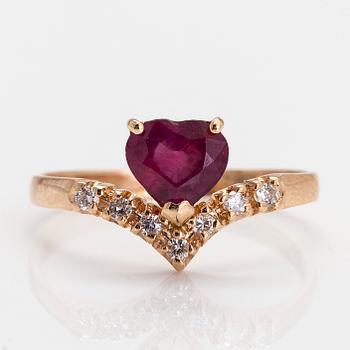 A 14K gold ring, with a heart-shaped ruby and diamonds.