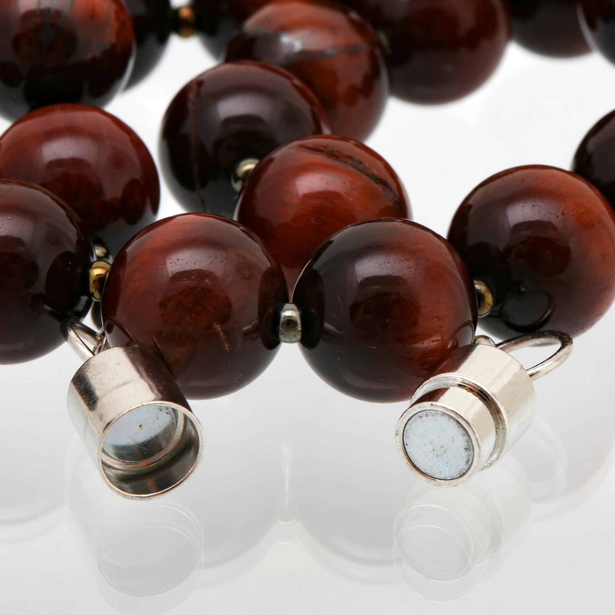 Collier tigeröga kulor ca 12 mm och mindre glaskulor, lås i metall, ca 50 cm.