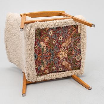 An oak easy chair with sheepskin upholstery. second part of the 20th Century.