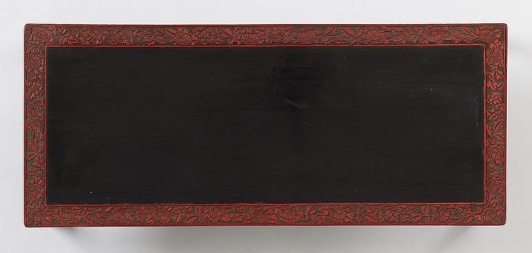 A carved lacquered table, early 20th Century.