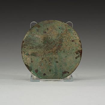 A bronze mirror decorated with a highly stylized dragon-pattern, Han dynasty (206 BC - AD 220).