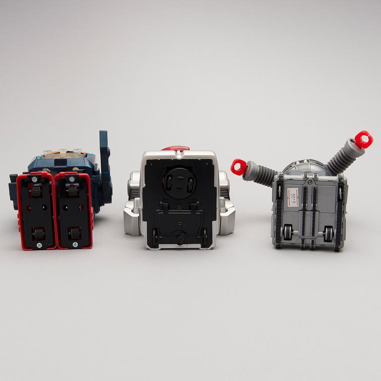 Three Vintage Toy Robots and a Table Clock.