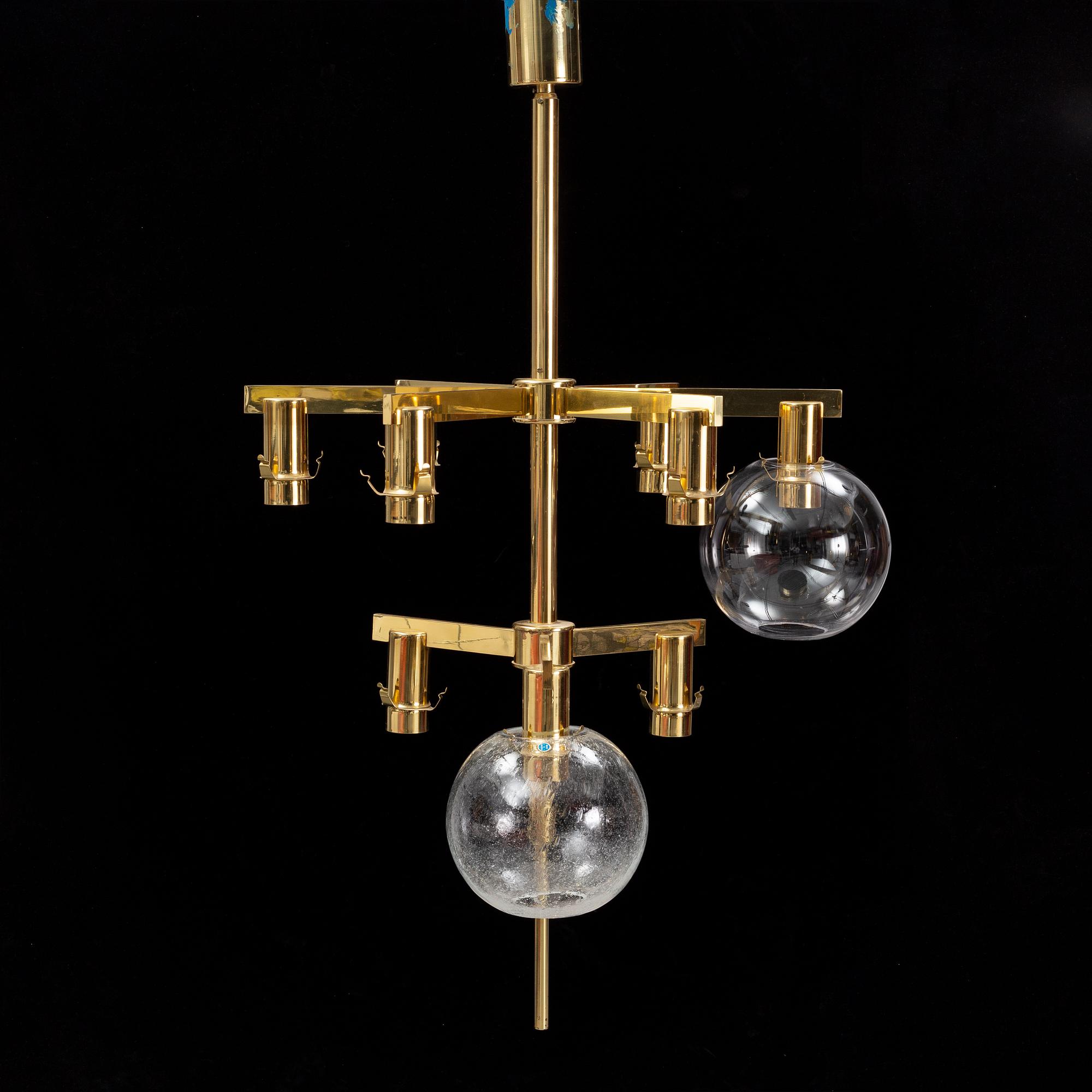 A brass chandelier with two glass globes by Hans-Agne Jacobsson, Markaryd.