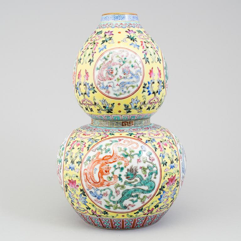 A chinese famille rose double gourd vase. Second half of the 20th century, with Qianlongs mark to the base.