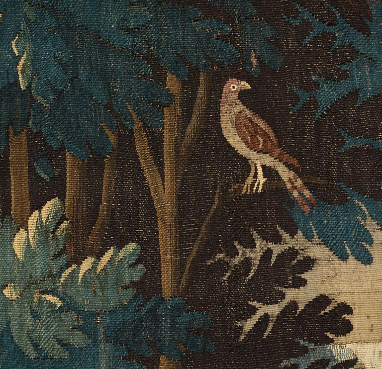 A TAPESTRY, tapestry weave, a "Verdure",  ca 304 x 224,5 cm, Flanders 17th century, signed "W" a lily "B".