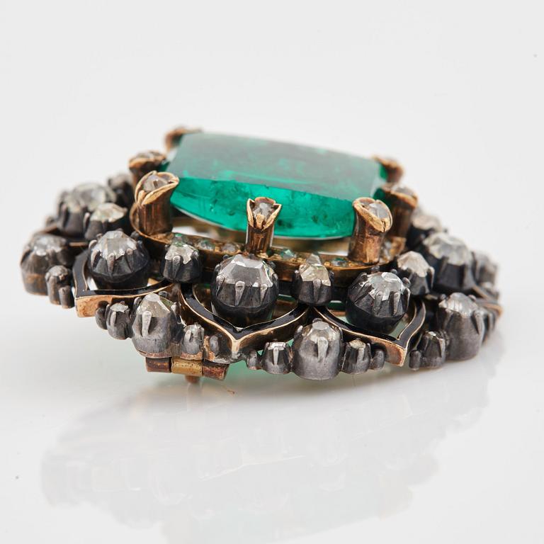An emerald, black enamel and old cut diamond brooch. 19th century.