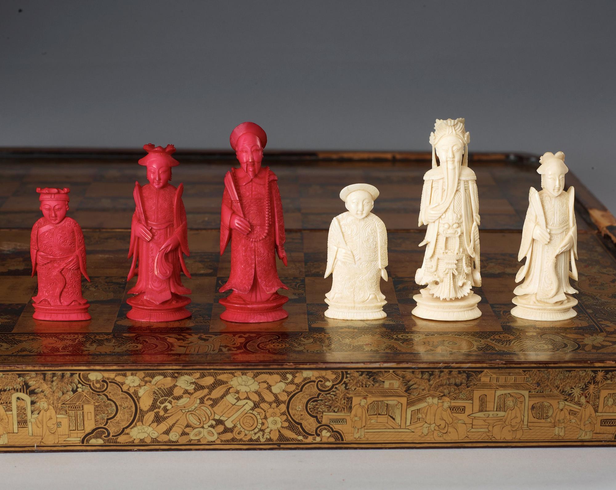 A black lacquer chess game with 32 + 38 ivory and bone figures, late Qing dynasty (1644-1912).