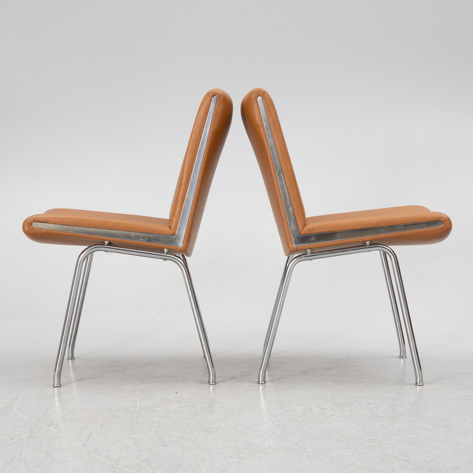 Hans J. Wegner, a pair pf "Kastrup Airport" lounge chairs, Denmark, late 20th century.