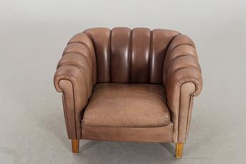 A leather sofa and armchair, 20th century latter part.