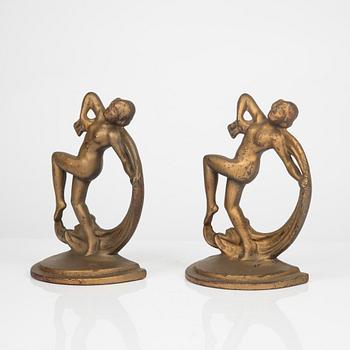 A pair of bronze patinated metal book stands, 1900´s.