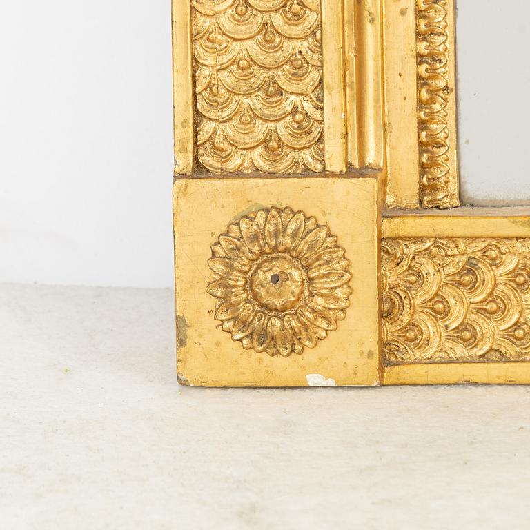An Empire mirror, first half of the 19th century.