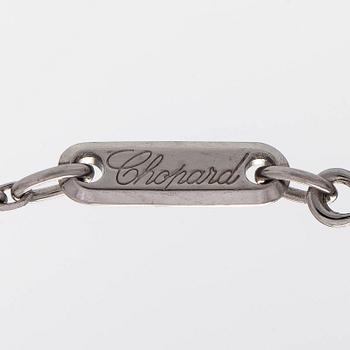 Chopard, an 18K whitegold 'Happy Diamonds" cross necklace set with diamonds.