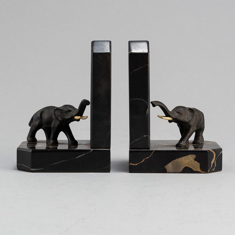 a pair of bronze and stone bookends from the first half of the 20th century.