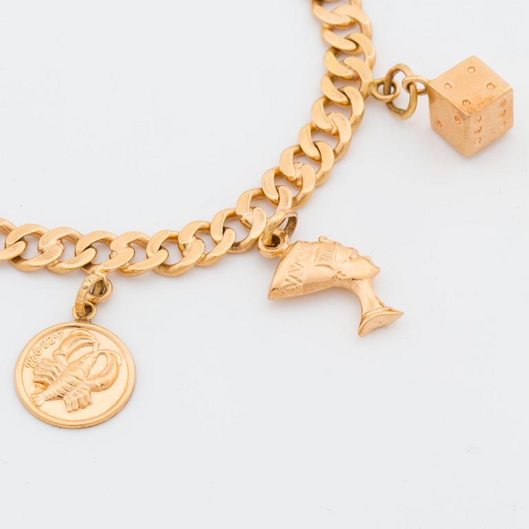 BRACELET 18K GOLD WITH 8 CHARMS.