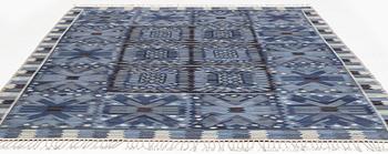 454. Barbro Nilsson, a carpet, "Nejlikan blå", flat weave, ca 315 x 272 cm, signed AB MMF BN.
