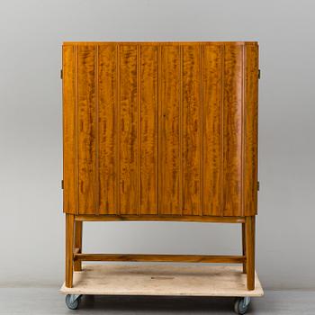 A Swedish Modern birch cabinet dated 1945.